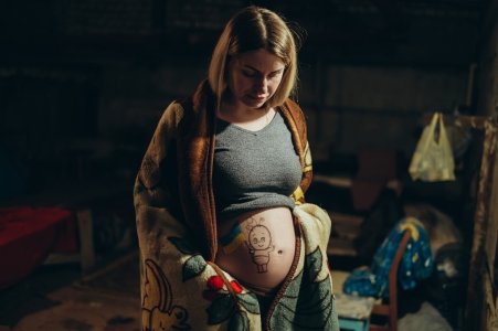 War in Ukraine. A Ukrainian pregnant woman hides in a bomb shelter while resisting a Russian invasion.